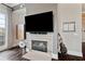 Cozy fireplace with a modern TV setup and stylish decor at 58 Canton St # 404, Alpharetta, GA 30009