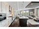Open-concept kitchen with a large island, modern appliances, and seamless flow to living area at 58 Canton St # 404, Alpharetta, GA 30009