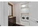 Well-lit laundry room with cabinets, countertop space and in-unit washer and dryer at 58 Canton St # 404, Alpharetta, GA 30009