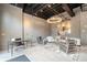 A living room with gray walls, a modern chandelier, and contemporary furniture, including a sofa and chairs at 58 Canton St # 404, Alpharetta, GA 30009