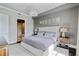 Comfortable main bedroom features soft decor and a decorative light fixture, with access to the bathroom at 58 Canton St # 404, Alpharetta, GA 30009