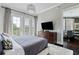 Bright main bedroom features a decorative light fixture, balcony, and TV with a dining room view at 58 Canton St # 404, Alpharetta, GA 30009