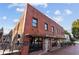 South Main Kitchen exterior view showing the historic brick building and outdoor umbrella seating at 58 Canton St # 404, Alpharetta, GA 30009