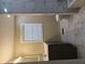Bathroom with white tiled walls, modern vanity and window at 6136 Holiday Blvd, Forest Park, GA 30297