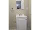 Bathroom with a white vanity, a modern sink, a mirror, a towel rack, and neutral-colored walls at 6136 Holiday Blvd, Forest Park, GA 30297