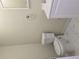 Bathroom with neutral walls, tile floors, and white toilet and vanity at 6136 Holiday Blvd, Forest Park, GA 30297