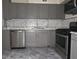 Updated kitchen with stainless steel appliances and modern gray cabinets at 6136 Holiday Blvd, Forest Park, GA 30297
