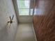 Bright living area featuring hardwood floors, a fan, and a large window that lets in natural light at 6136 Holiday Blvd, Forest Park, GA 30297