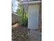 Side yard of the home shows a glimpse of a brick wall at 6136 Holiday Blvd, Forest Park, GA 30297