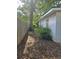 Side yard of the home shows a glimpse of a fence and trees at 6136 Holiday Blvd, Forest Park, GA 30297