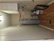 Neutral utility room with water heater, shelving and storage space above with laminate flooring at 6136 Holiday Blvd, Forest Park, GA 30297