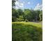 A vibrant green grassy yard presents a welcoming outdoor space at 6136 Holiday Blvd, Forest Park, GA 30297