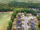A community bordered by a lush green forest features neatly arranged homes with mature trees at 114 Brookstone Dr, Carrollton, GA 30116