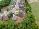 Aerial view of a home nestled among trees, near a baseball field, highlighting the neighborhood's serene and recreational amenities at 114 Brookstone Dr, Carrollton, GA 30116