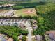 An aerial view showcases the neighborhood, featuring tree-lined streets, nearby baseball fields, and well-maintained homes at 114 Brookstone Dr, Carrollton, GA 30116