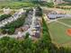 This aerial view highlights the home's location within a community near a baseball field, and a pond at 114 Brookstone Dr, Carrollton, GA 30116