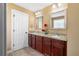 This well-lit bathroom features granite counters, dual sinks and dark wood cabinetry at 114 Brookstone Dr, Carrollton, GA 30116