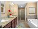 Bright bathroom features granite counters, double sinks, soaking tub and shower with glass doors at 114 Brookstone Dr, Carrollton, GA 30116
