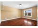A bedroom with hardwood floors, a window with natural light, and closet organization rack at 114 Brookstone Dr, Carrollton, GA 30116