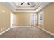 Bedroom featuring tray ceilings, carpet, natural light, and neutral walls, offering a calming space at 114 Brookstone Dr, Carrollton, GA 30116