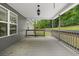 The covered porch offers a serene outdoor space, perfect for relaxing and enjoying the surrounding landscape at 114 Brookstone Dr, Carrollton, GA 30116
