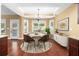 Bright dining area with many windows, chandelier lighting, and neutral wall coloring at 114 Brookstone Dr, Carrollton, GA 30116