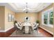 Formal dining room with tray ceilings, chandelier, and an elegant marble table and chairs at 114 Brookstone Dr, Carrollton, GA 30116