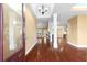 Open entryway with hardwood floors, white columns, and views of the kitchen and living spaces at 114 Brookstone Dr, Carrollton, GA 30116