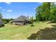 The landscaped yard surrounds a lovely home with a covered porch at 114 Brookstone Dr, Carrollton, GA 30116