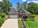 Inviting two-story home featuring stone accents, a two-car garage, and a beautifully landscaped yard at 114 Brookstone Dr, Carrollton, GA 30116