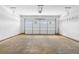 A large, empty garage with white walls and garage door at 114 Brookstone Dr, Carrollton, GA 30116
