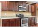 Kitchen boasts granite countertops, stainless appliances, dark cabinetry, and lots of countertop space at 114 Brookstone Dr, Carrollton, GA 30116