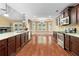Open kitchen boasts dark cabinets, granite counters, stainless appliances, and a view to the dining area at 114 Brookstone Dr, Carrollton, GA 30116