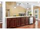 Open concept eat-in kitchen features granite island, stainless appliances, and fireplace in living room at 114 Brookstone Dr, Carrollton, GA 30116
