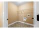 A practical laundry room features tile floors, storage shelving, and conveniently placed washing machine hookups at 114 Brookstone Dr, Carrollton, GA 30116