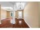 Spacious living room with hardwood floors, tray ceilings, white columns and neutral paint at 114 Brookstone Dr, Carrollton, GA 30116