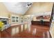 Open-concept living room featuring hardwood floors, a stone fireplace, and a view into the kitchen at 114 Brookstone Dr, Carrollton, GA 30116