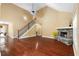 Living area features tall ceilings, a fireplace with stone surround, and a staircase to the second floor at 114 Brookstone Dr, Carrollton, GA 30116