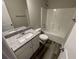 Clean bathroom with granite vanity, a sink, and a pristine white tub with shower combo at 115 Deer Xing, Temple, GA 30179