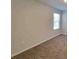 Cozy bedroom with neutral carpet, a window for natural light, and a minimalist aesthetic at 115 Deer Xing, Temple, GA 30179