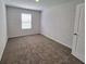 Simple bedroom with a carpet, a window providing natural light, and a minimalist style at 115 Deer Xing, Temple, GA 30179