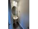 This half bathroom features a modern pedestal sink, vanity mirror, and attractive lighting at 115 Deer Xing, Temple, GA 30179