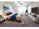 Relaxing main bedroom suite with accent wall, tv, and luxurious bedding, offering a private and serene retreat at 115 Deer Xing, Temple, GA 30179
