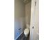 Clean and simple powder room, featuring a white toilet and neutral wall color, perfect for guests at 115 Deer Xing, Temple, GA 30179
