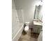Bathroom featuring granite countertops, a tub, and light wood flooring at 123 Deer Xing, Temple, GA 30179