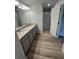 Bright bathroom featuring double sinks, granite countertops, and a glass-enclosed shower at 123 Deer Xing, Temple, GA 30179