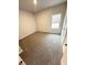 Neutral bedroom featuring carpet flooring, paint and one large window at 123 Deer Xing, Temple, GA 30179