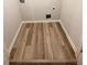 A dedicated laundry area with wood-look floors and hook ups at 123 Deer Xing, Temple, GA 30179