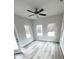 Bright living room featuring three large windows and a ceiling fan at 123 Deer Xing, Temple, GA 30179