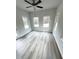Bright living room with grey wood flooring, neutral paint, and multiple windows at 123 Deer Xing, Temple, GA 30179